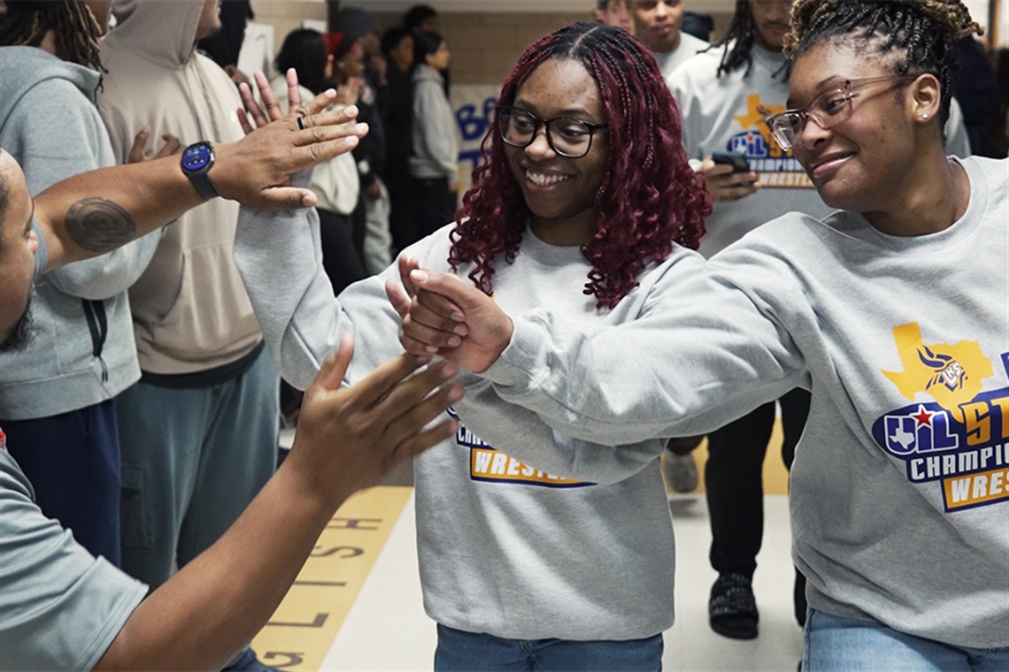 Adaugo Onyekwere high-five's teammates. 