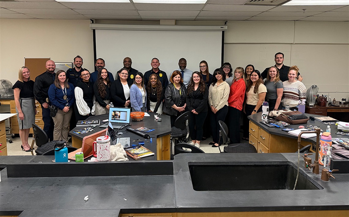 APD Personnel posing with UTA Criminology Students