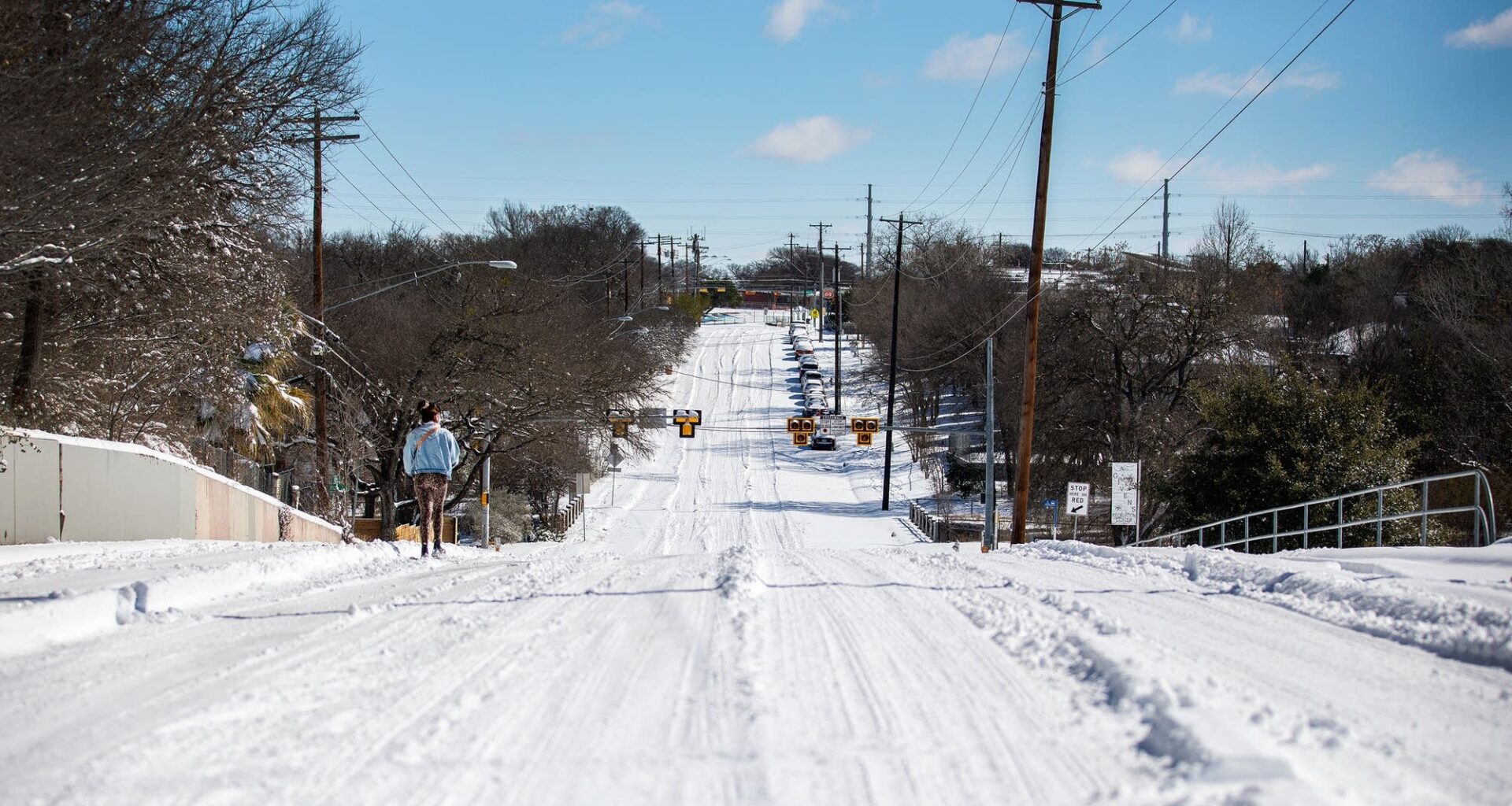 A person walks on an empty street in East Austin, Texas, in February 2021 during Winter Storm Uri. Since then, a lot of Texas' energy infrastructure has been winterized.
