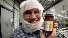 Doug Renfro, with Renfro Foods, holds a bottle of salsa with his grandmother's smiling face on the label.