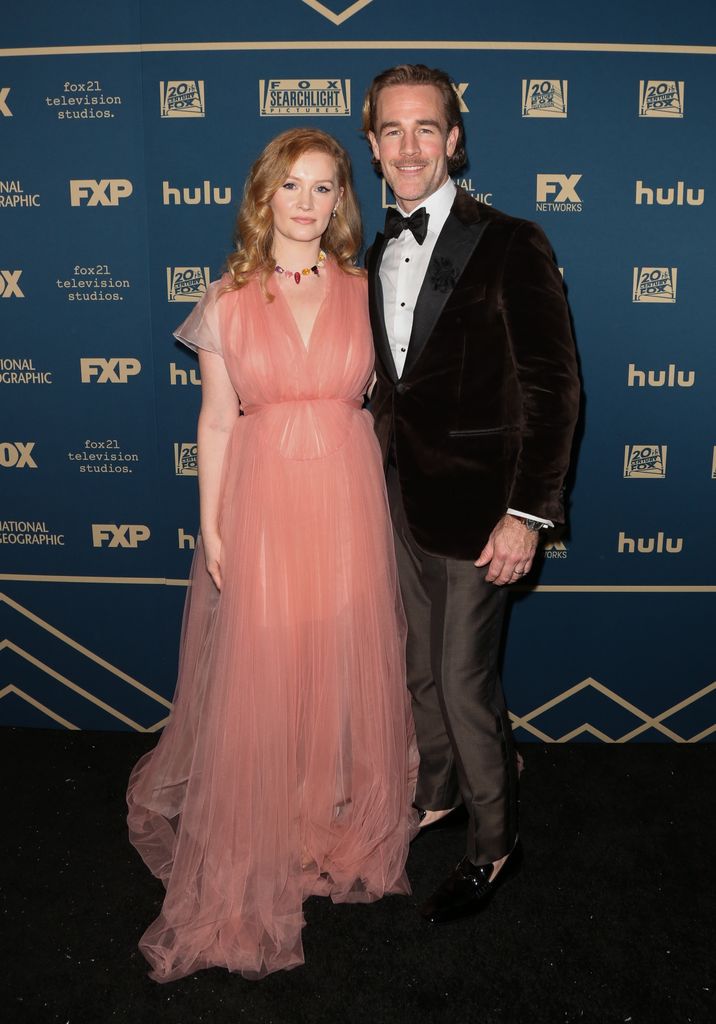 James Van Der Beek  in black suit and wife Kimberly Brook in pink dress