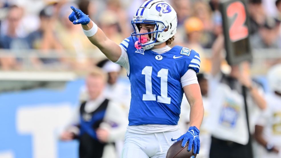 ORLANDO, FLORIDA - DECEMBER 27: Parker Kingston #11 of the BYU Cougars reacts after a first down against the Georgia Tech Yellow Jackets in the first half during the 2025 Pop-Tarts Bowl at Camping World Stadium on December 27, 2025 in Orlando, Florida. (Photo by Julio Aguilar/Getty Images)