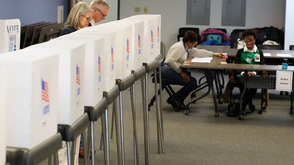 Republican US Senate candidate Michael Whatley, second from left, and his wife Suzanne cast their votes at an early voting site on February 12, in Gastonia, North Carolina. - Erik Verduzco/AP