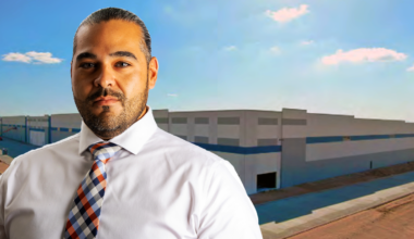 A picture of Rudy Cruz, Jr. in front of a warehouse rumored to be a future ICE detention facility.