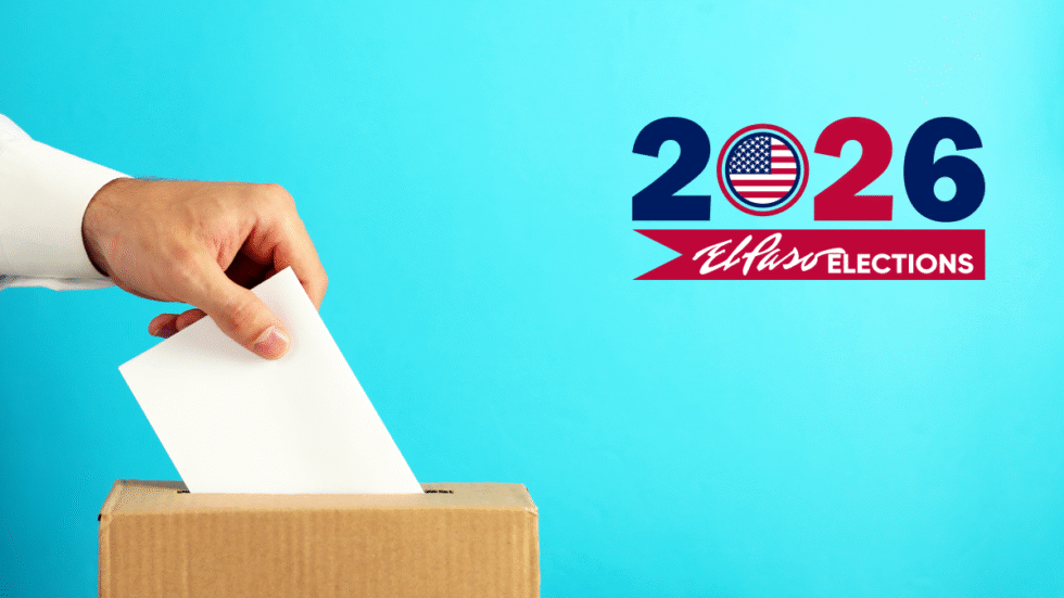 A picture of a hand dropping a ballot into a box.