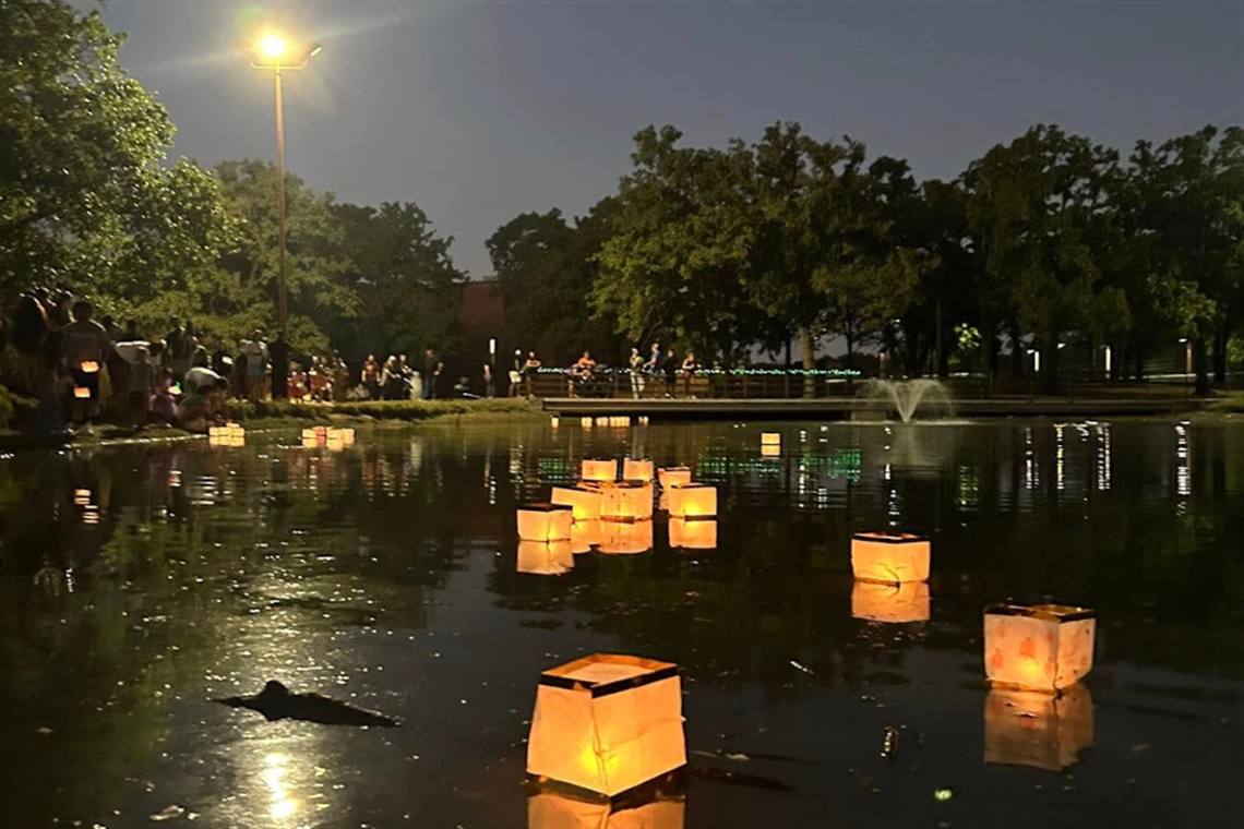 Floating lanterns on Cliff Nelson pond at night