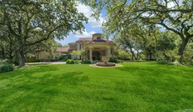 This Elm Creek mansion for sale includes a full bar in the living room and a secret gun closet