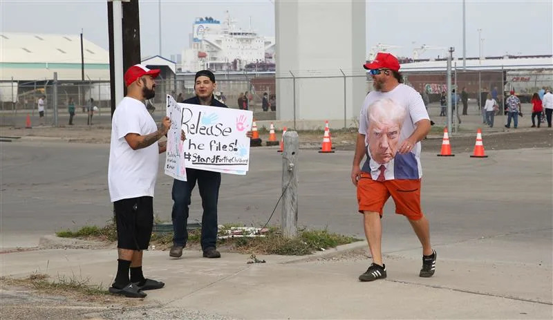 Brandon Garis, right, passes protesters outside the Ortiz Center, where President Donald Trump was expected to make remarks on Feb. 27, 2026.
