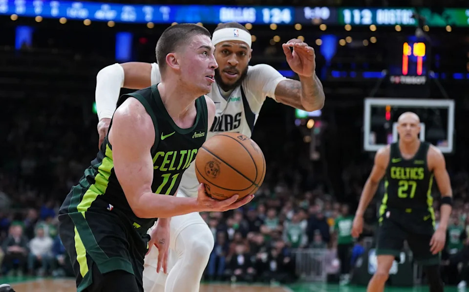 Feb 6, 2025; Boston, Massachusetts, USA; Boston Celtics guard Payton Pritchard (11) drives the ball against Dallas Mavericks center Daniel Gafford (21) in the second half at TD Garden. Mandatory Credit: David Butler II-Imagn Images