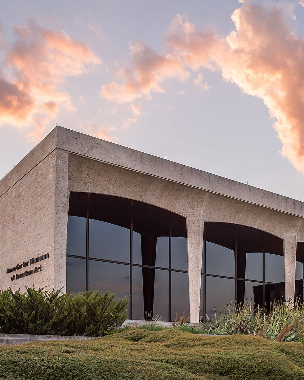 museum building with large windows reflecting the sky