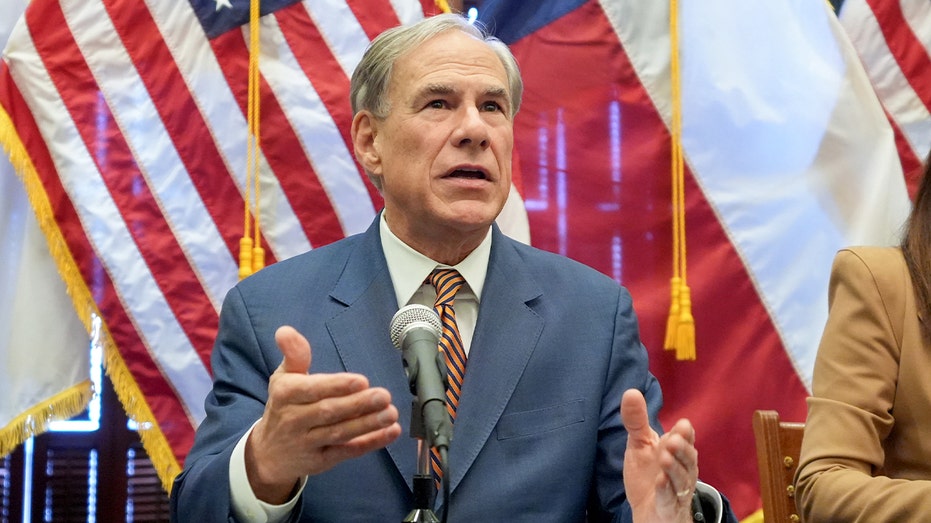Texas governor speaks at a podium inside the Capitol alongside federal officials.