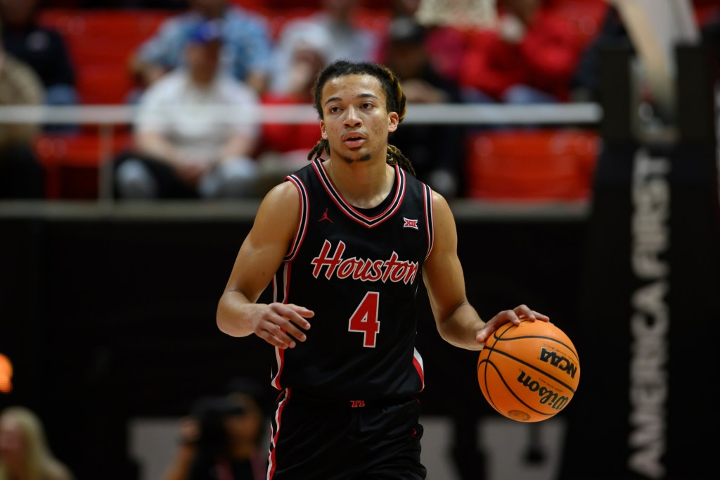 Houston guard Kingston Flemings bringing the ball up court.