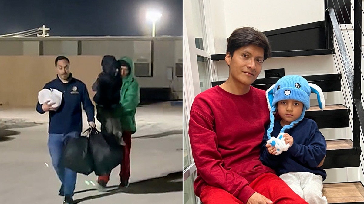 Man carries a child while walking outside at night.