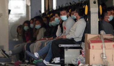 Migrants wearing face masks and shackles on their hands and feet sit on a military aircraft at Fort Bliss in El Paso, Texas, Jan. 30, 2025, awaiting their deportation to Guatemala. (AP Photo/Christian Chavez)