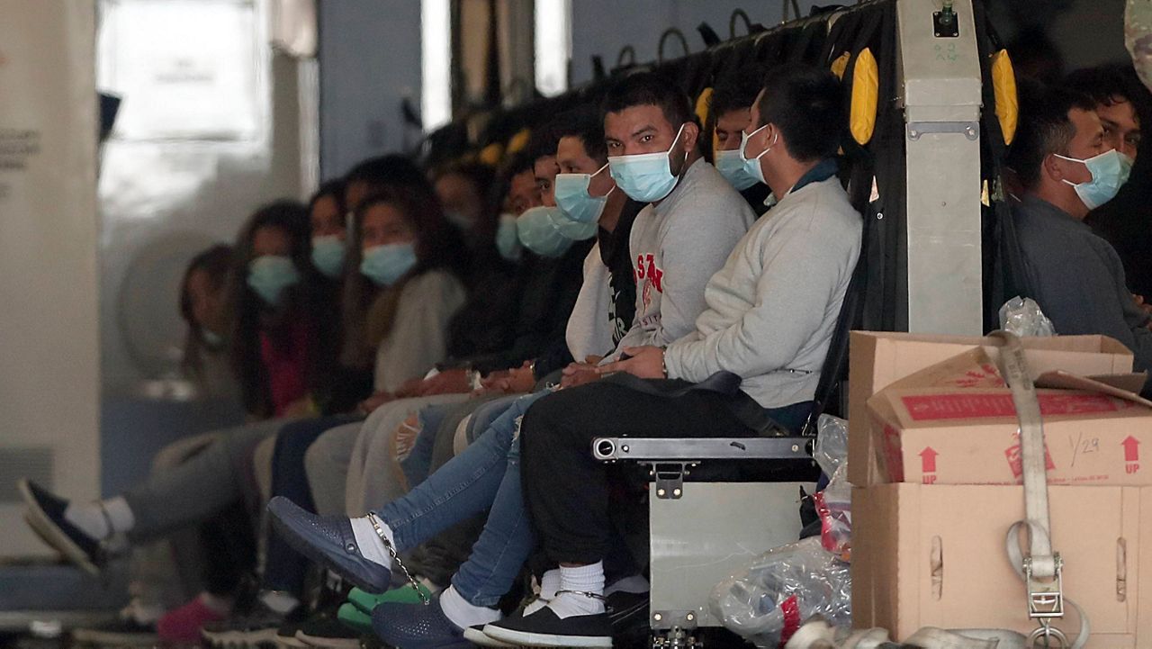 Migrants wearing face masks and shackles on their hands and feet sit on a military aircraft at Fort Bliss in El Paso, Texas, Jan. 30, 2025, awaiting their deportation to Guatemala. (AP Photo/Christian Chavez)