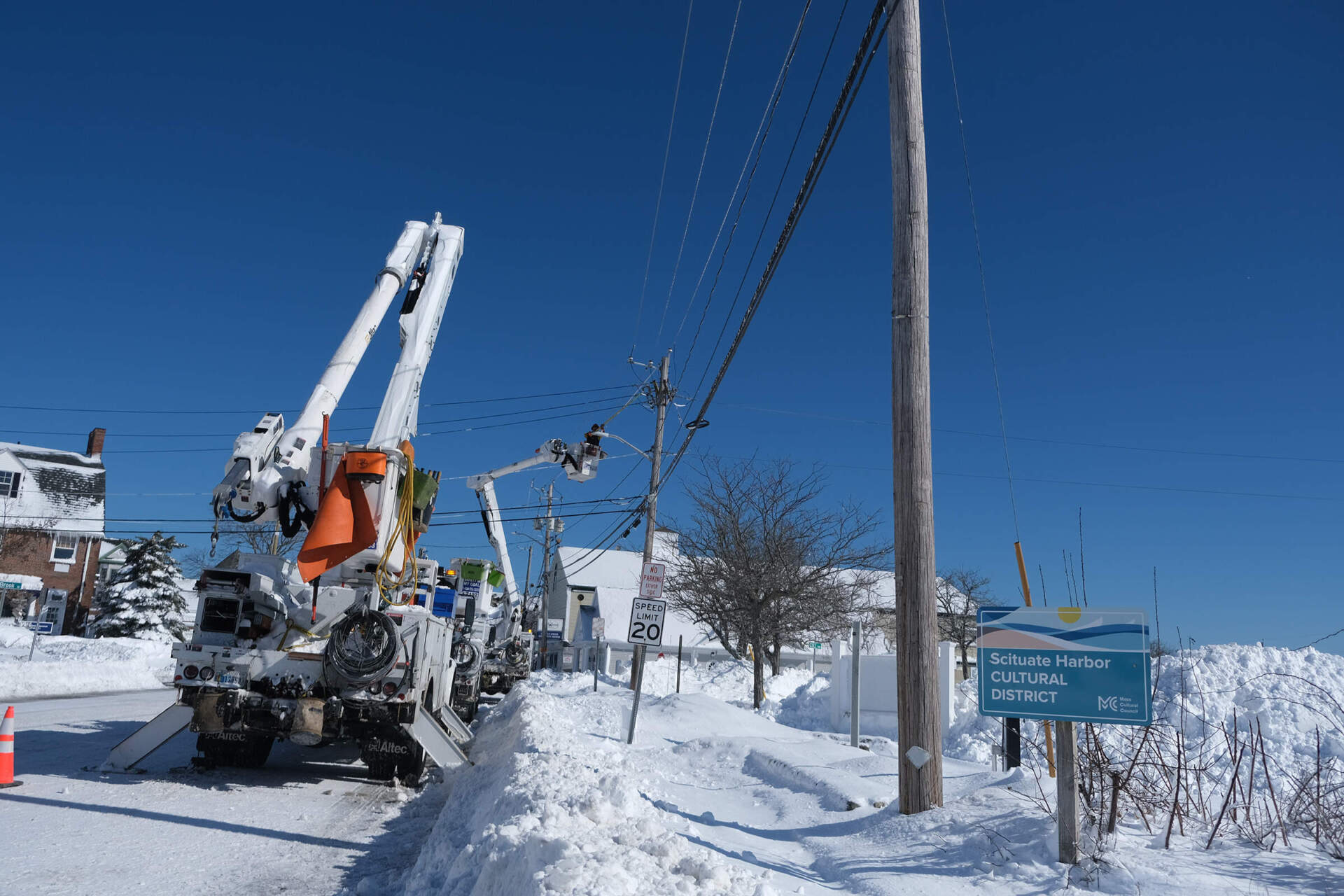 Utility workers repair a power line in Scituate on Tuesday. (Patrick Madden/WBUR)