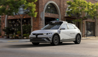 A Waymo autonomous taxi driving on a city street