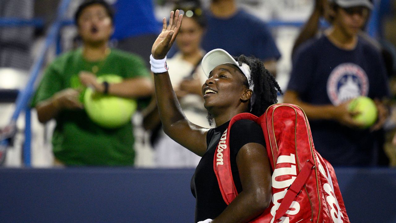 Venus Williams waves to the crowd as she leaves the court after she lost to Magdalena Frech, of Poland, during a match at the Citi Open tennis tournament Thursday, July 24, 2025, in Washington. (AP Photo/Nick Wass)