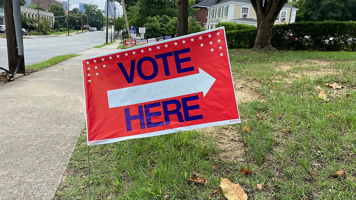 "Vote here" sign outside a polling place. (Spectrum News)