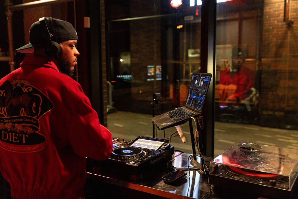 Facing the studio windows, DJ MEZ.WAV spins a set live for Central on Air. (Robin Lubbock/WBUR)