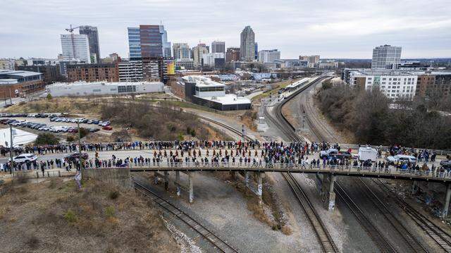 A procession of Buddhist monks walks across Boylan Bridge in downtown Raleigh, followed by hundreds of well-wishers on Jan. 24. The monks made a 2,300-mile pilgrimage from Texas to Washington, D.C., as part of the Walk for Peace, an effort to promote peace, compassion and national unity.