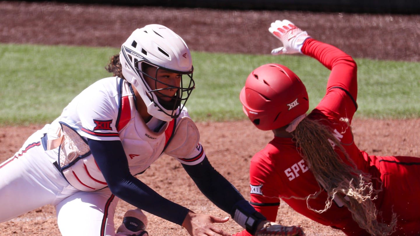 Texas Tech's Desirae Spearman scores a run around Arizona catcher Sydney Stewart during a Big 12 Conference softball game, Saturday, March 14, 2026, at Rocky Johnson Field.