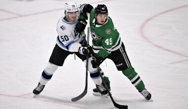 Mar 16, 2026; Dallas, Texas, USA; Utah Mammoth defenseman Sean Durzi (50) and Dallas Stars center Justin Hryckowian (49) battle for position during the first period at the American Airlines Center. Mandatory Credit: Jerome Miron-Imagn Images