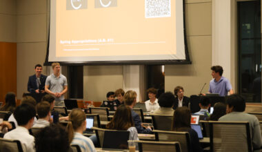 Charlier Weiner, speaker pro-tem (right, at podium) announces to Financial Affairs Chair Jace Jones (far left) and Executive Financial Director Luke Grismer (left) that the Spring Appropriations passed unanimously at the Student Government Assembly meeting on Feb. 17, 2026. The appropriations vote stalled for two weeks after debate over whether UT's chapter of Turning Point USA should recieve funding.