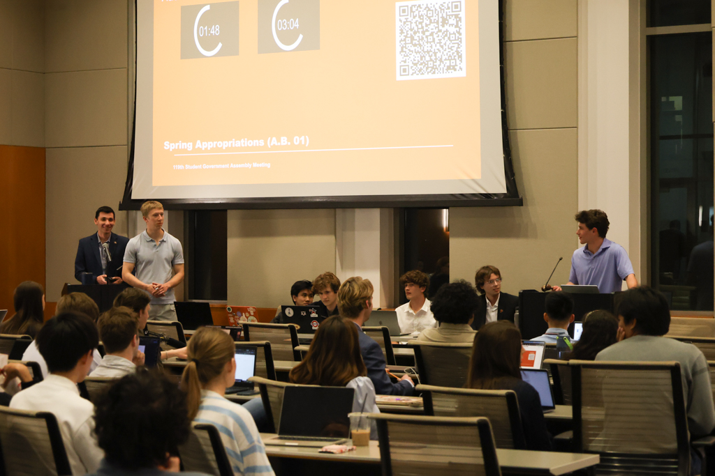 Charlier Weiner, speaker pro-tem (right, at podium) announces to Financial Affairs Chair Jace Jones (far left) and Executive Financial Director Luke Grismer (left) that the Spring Appropriations passed unanimously at the Student Government Assembly meeting on Feb. 17, 2026. The appropriations vote stalled for two weeks after debate over whether UT's chapter of Turning Point USA should recieve funding.