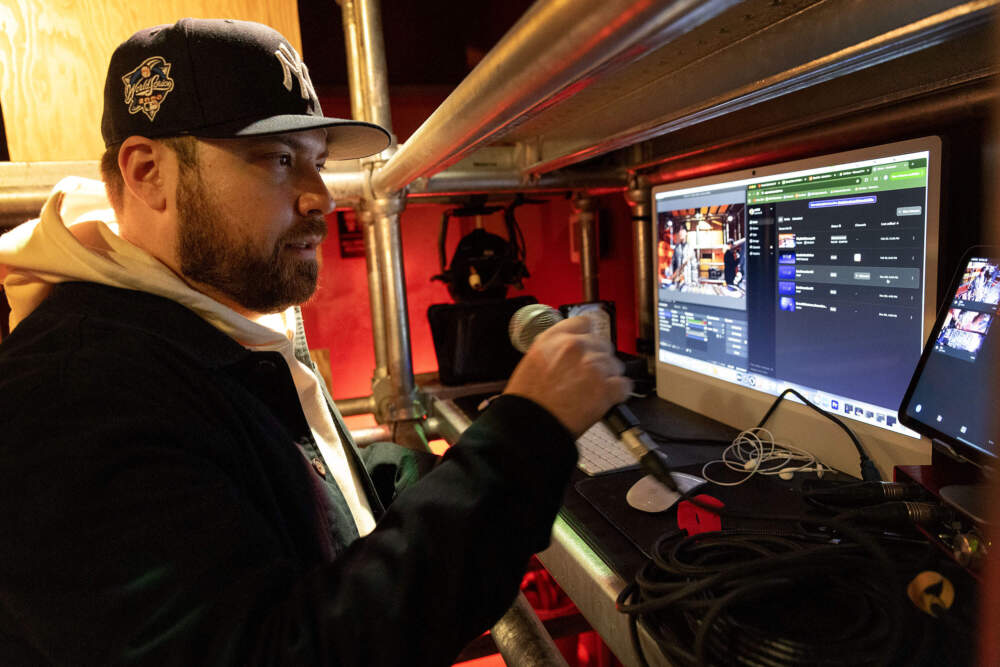 Central Square Business Improvement District program director Erik Sarno looks over the streaming controller at the Central on Air studio in Cambridge, Mass. (Robin Lubbock/WBUR)