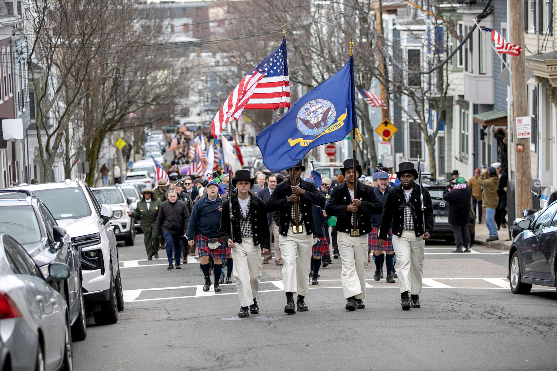 Members of the crew of the USS Constitution lead a procession towards Dorchester Heights to commemorate the 250th Anniversary of the end of the Siege of Boston, and Evacuation Day. (Robin Lubbock/WBUR)