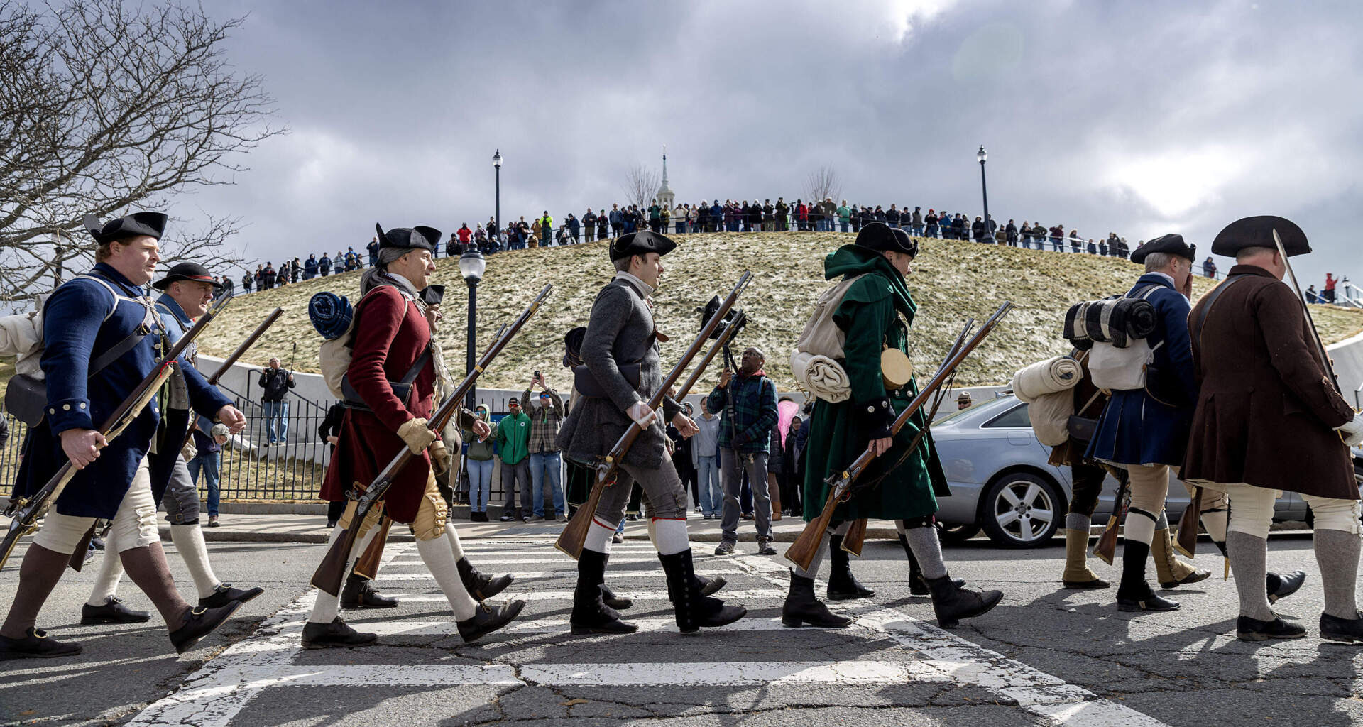Reenactors march along Dorchester Heights during the 250th anniversary of Evacuation Day. (Robin Lubbock/WBUR)