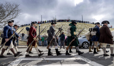 Reenactors march along Dorchester Heights during the 250th anniversary of Evacuation Day. (Robin Lubbock/WBUR)