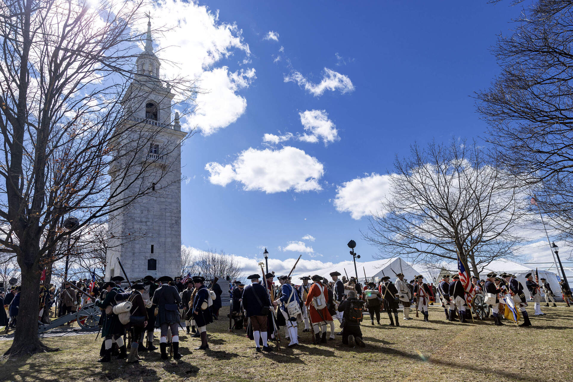 Re-enactors assembled on Telegraph Hill by the newly restored Dorchester Heights Monument, during the commemoration for the 250th anniversary of the end of the Siege of Boston. (Robin Lubbock/WBUR)