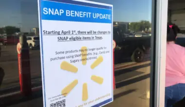 A sign outside a Walmart that reads "SNAP benefit update: Starting April 1, there will be changes to SNAP eligible items in Texas. Some products may no longer qualify for purchase using SNAP benefits (e.g. Candy and Sugary snacks/drinks)." The text is over the Walmart logo, which includes six yellow shapes that look like flower petals arranged in a circle. The sign also includes a QR code and the words "Thank you for your understanding!" at the bottom in yellow text.