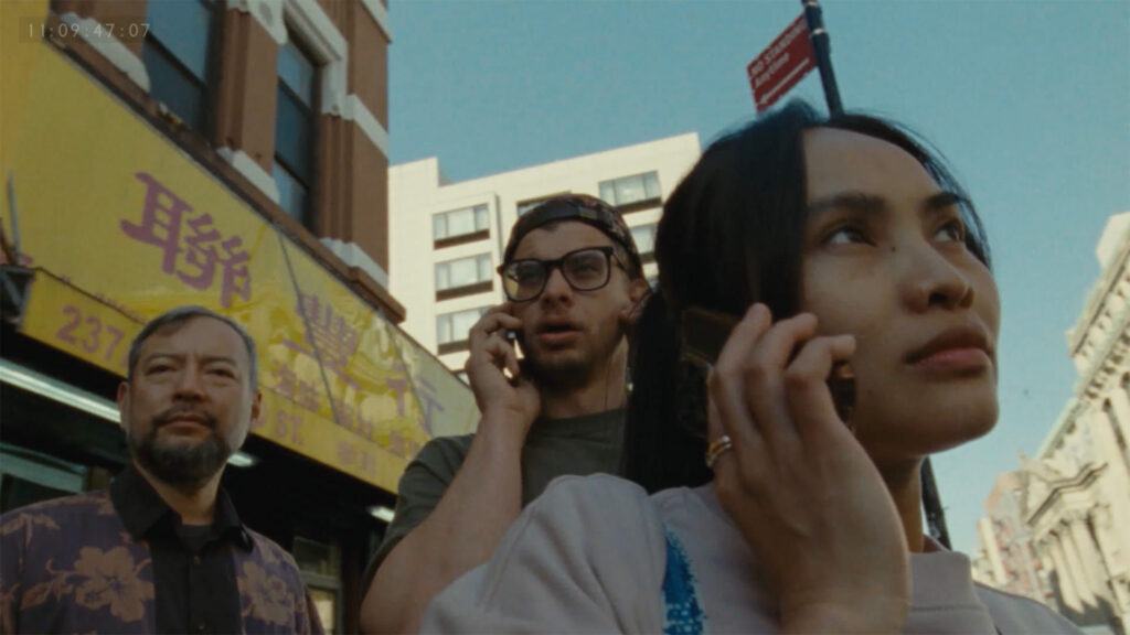 Two people are on their cell phones in a still image from the film 