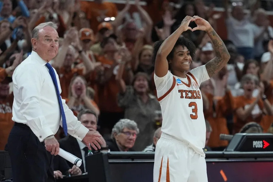 Texas guard Rori Harmon (3) celebrates with head coach Vic Schaefer during the second half in the second round of the NCAA college basketball tournament against Oregon, Sunday, March 22, 2026, in Austin, Texas. (AP Photo/Eric Gay)