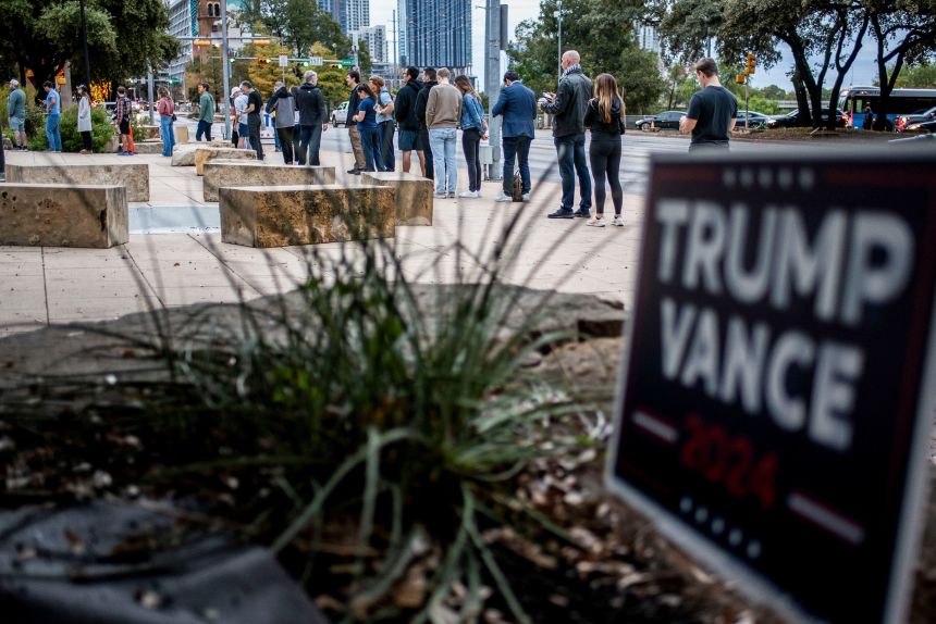 Voters wait in line at a polling location for the 2024 presidential election in Austin on November 5, 2024.
