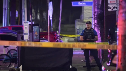 An Austin police officer guards the scene on West 6th Street at West Avenue after a shooting on Sunday, March 1, 2026, in Austin, Texas.