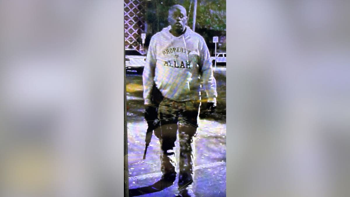 Austin shooting suspect wearing hoodie referencing Allah and carrying rifle.