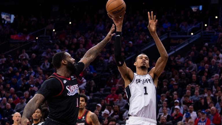 San Antonio Spurs' Victor Wembanyama, right, shoots the ball as...