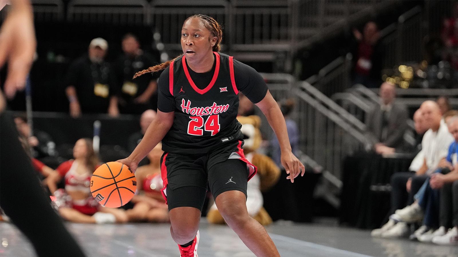 Jorynn Ross running towards teammates during starting lineups with mini basketball in hand