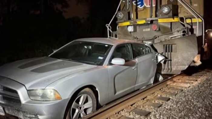 Train crashes into vehicle after driver loses control and lands on tracks