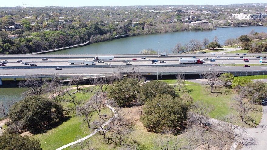 An aerial view showing parts of Edward Rendon Park, the I-35 bridge over Lady Bird Lake and Waller Beach Park