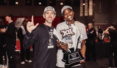 Wes Kittley holding the Big 12 Indoor trophy
