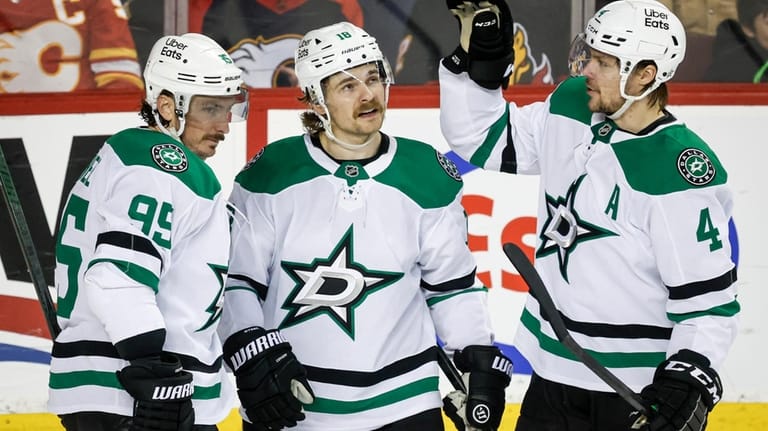 Dallas Stars' Sam Steel, center, celebrates his goal with teammates...