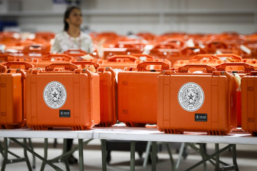 Election workers organize voting machines after election day Wednesday in Dallas.