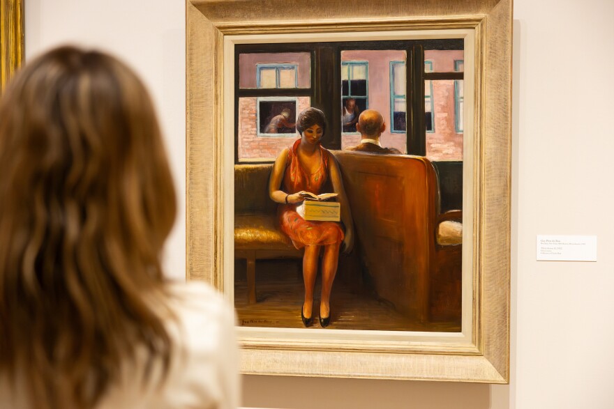 A tour participant looks at a painting by Guy Pène du Bois in the upcoming exhibit, “American Modernism from the Charles Butt Collection: From Edward Hopper to Alma Thomas."