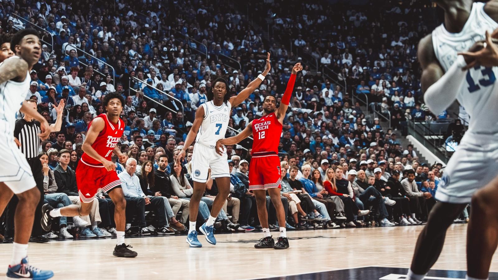 Christian Anderson drives past a BYU defender for a basket.