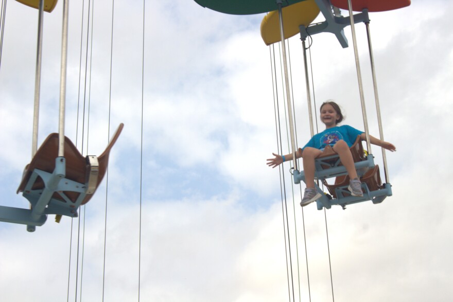 Girl flaps her arms to control how high she rides WingZ of Wonder at Morgan's Wonderland